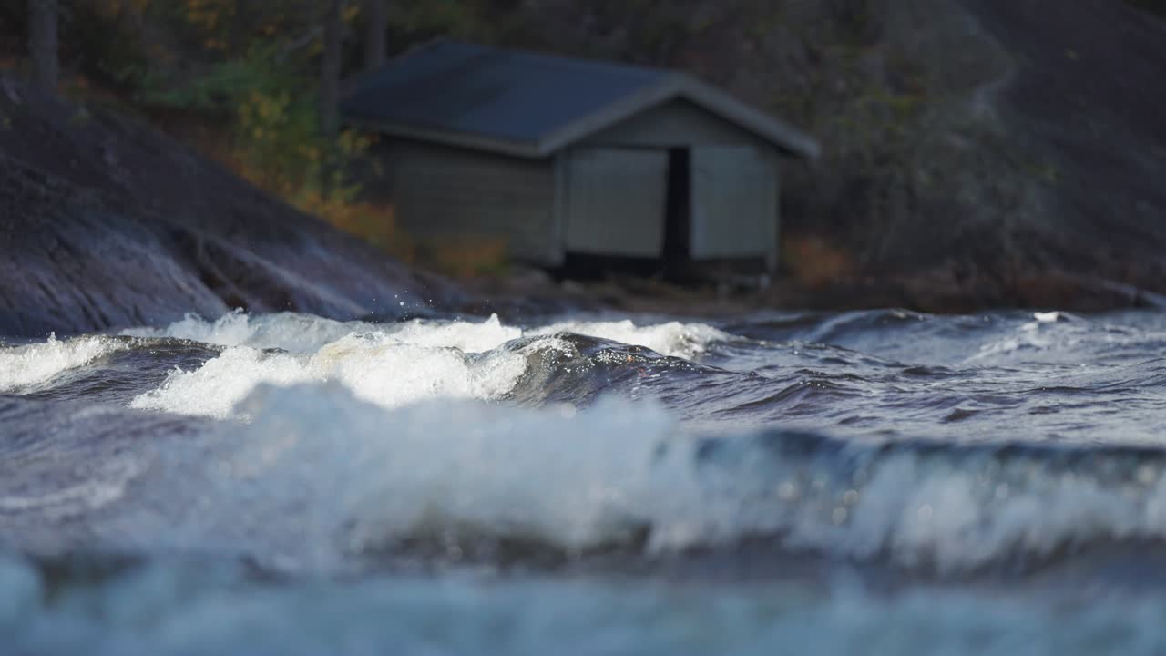 White-crested waves crash on the dark rocks