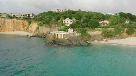 pan drone shot of baie rouge beach pavilion situated at bay of sea in saint martin