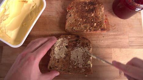 point of view shot showing person spreading butter on toast