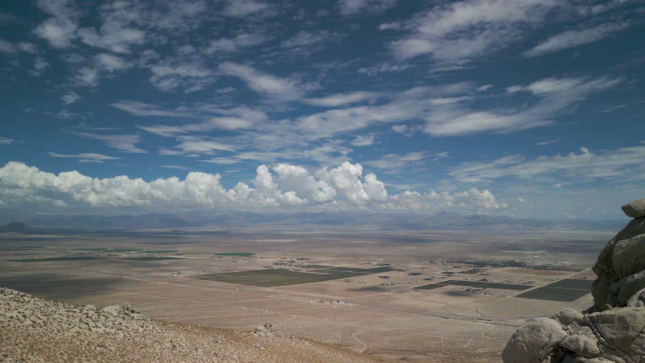 A drone sideways reveal of the Mojave desert behind a rocky outcrop