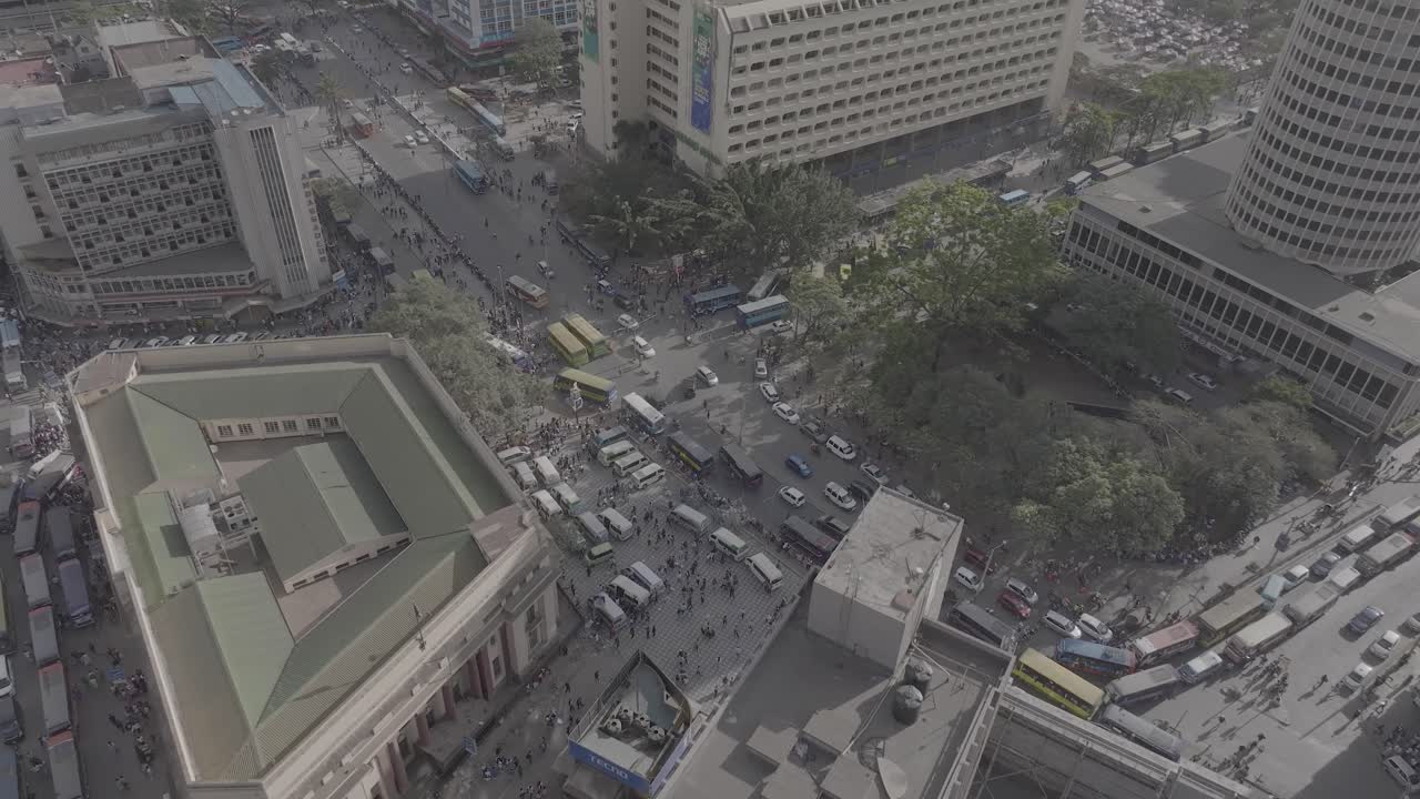Aerial drone of view close up of Nairobi, Kenya featuring urban busy traffic, matatus, pedestrians, buses, archives building, Hilton hotel, Ambassador hotel, KCB building and other infrastructure