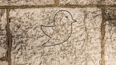 Animation-of-glowing-neon-bird-icon-on-brick-wall