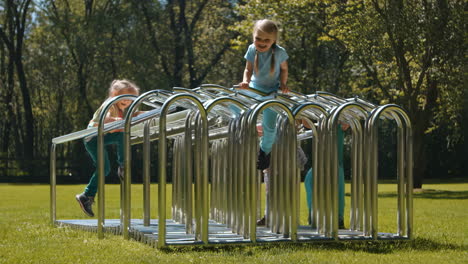 children playing on a climbing frame in a park