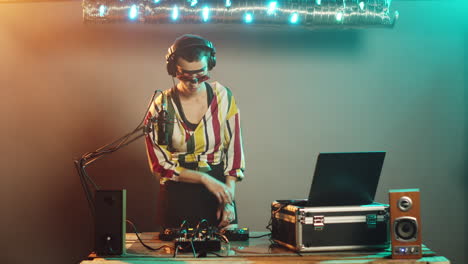 dj musician using turntables to mix techno sounds