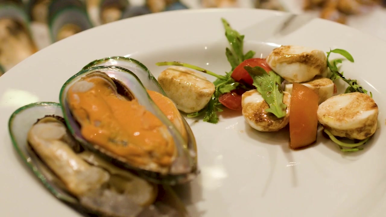 Serving Fresh Mussels and Caprese Salad on a Plate