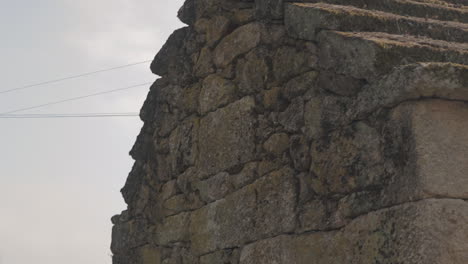 Slide-shot-of-a-stone-roof-of-a-communal-oven-in-a-rural-village-on-a-hill-Friaes-Tras-os-Montes-Portugal