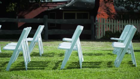 chairs arrange for an outdoor wedding ceremony during sunny morning