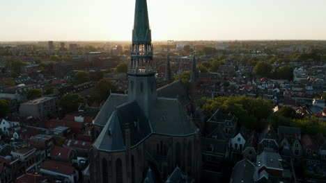 bright sunset at the cityscape of gouda with the historic church of gouwekerk in south holland, netherlands