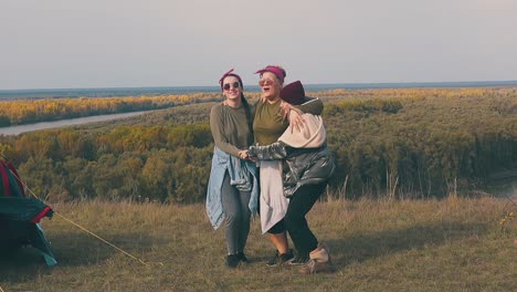 tipsy-ladies-jump-and-raise-hands-with-happiness-at-tent