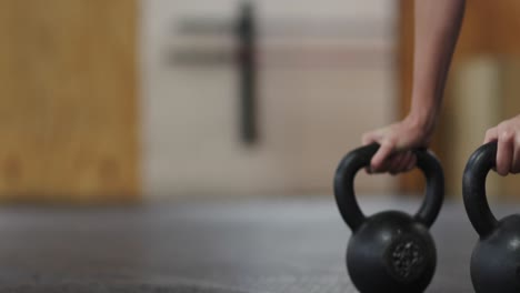 side view athletic caucasian woman holding kettlebell weights