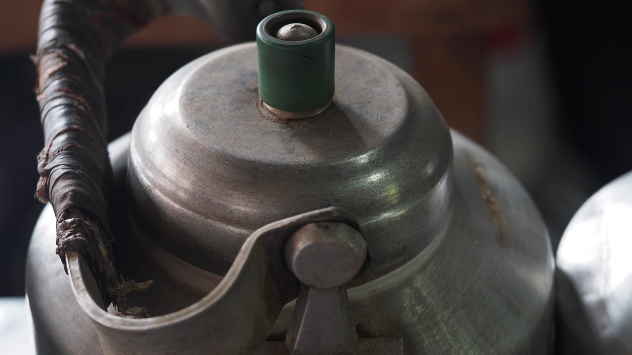 Close-up of an Old Metal Kettle Boiling and Steaming