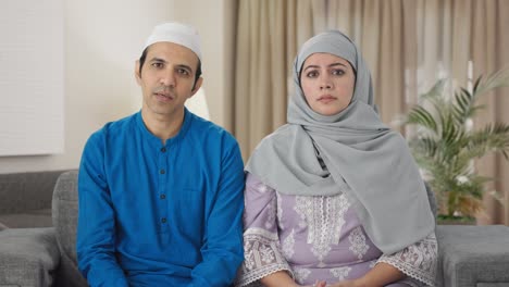 muslim couple talking to the camera