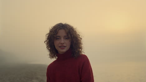 smiling woman posing on beach at sunrise. casual girl with happy face expression