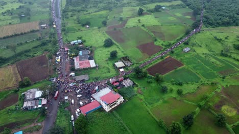 panoramic aerial view of the crowd of hindu devotees approaching a junction while taking on foot journey around the spiritual mountain of brahmgiri in trimbakeshwar, nashik, maharashtra, india