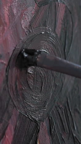 making circle strokes on canvas with abstract painting using brush on easel at art lesson in contemporary studio extreme close view slow motion