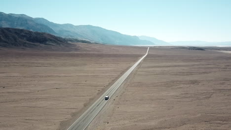 Aerial-Shot-Of-A-Car-Driving-In-Desert-Landscape-Of-Death-Valley-National-Park,-USA