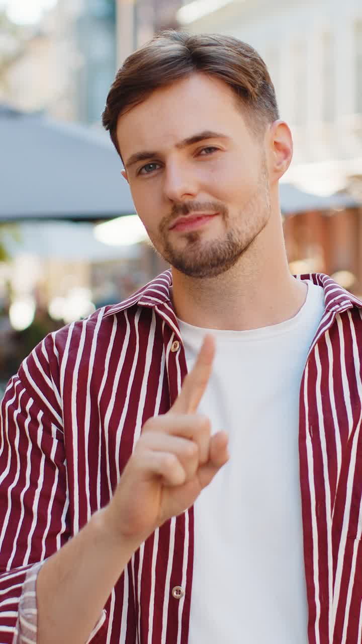 Displeased upset handsome adult man reacting to unpleasant awful idea wave hand finger shake head no