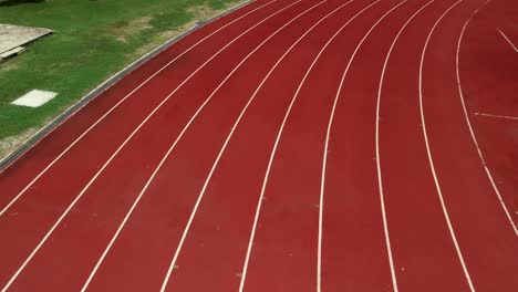 running track at the stadium, color is orange brick, high angle view by drone.