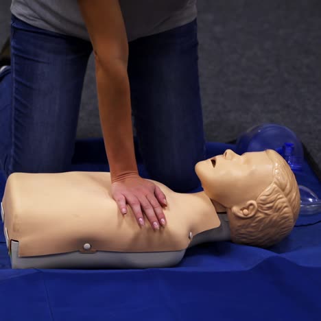 cpr training medical procedure. demonstrating chest compressions on cpr doll in the class. video from medical courses