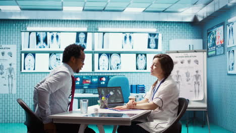 physician meets with a patient to discuss medical results in a cabinet