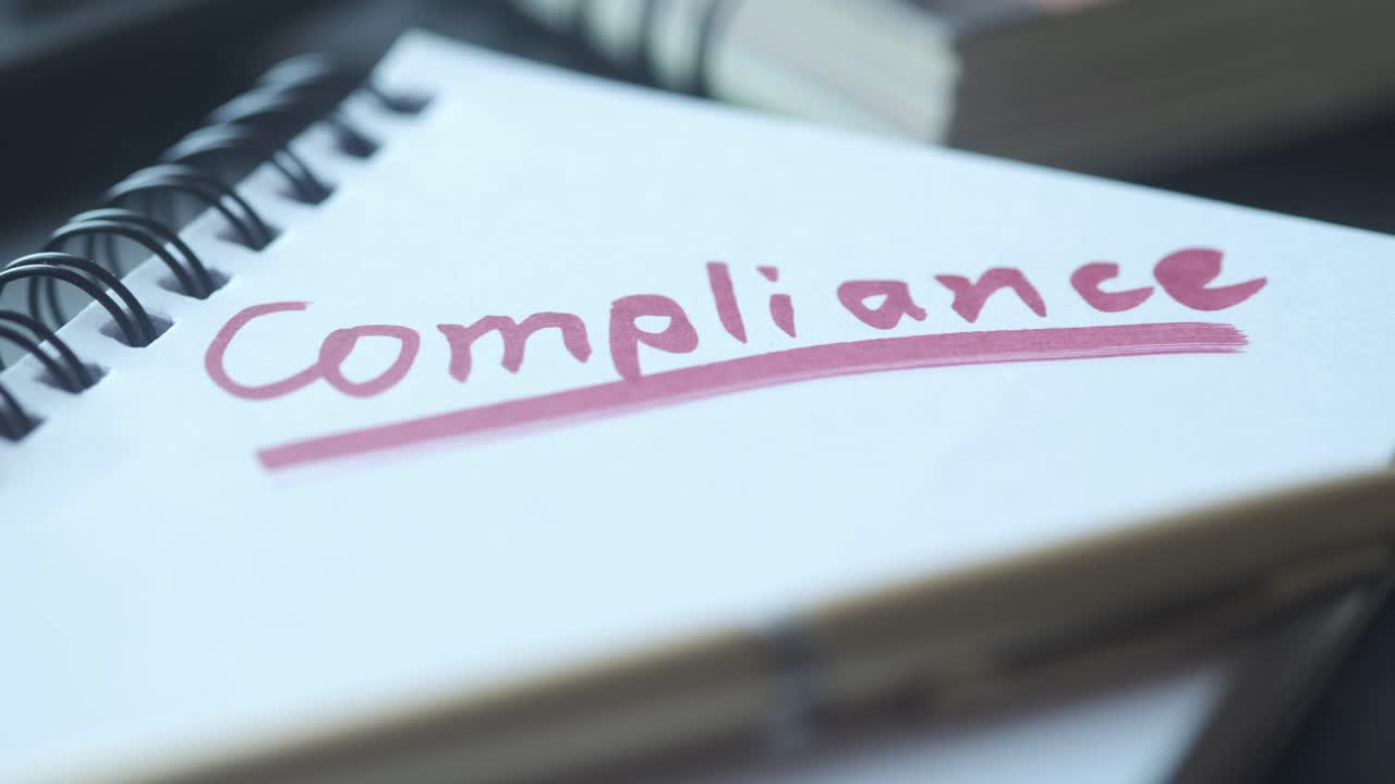 Compliance Written in a Notebook