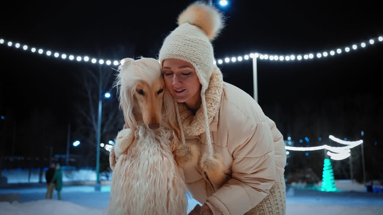Woman and her dog at night ice skating rink