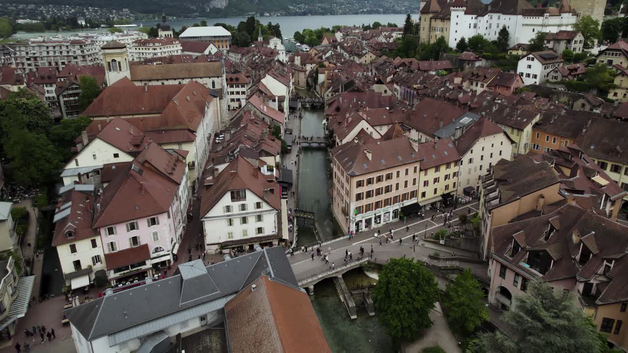 la ciudad alpina de annecy en francia con el río thiou, el castillo de annecy y el lago annecy a la vista