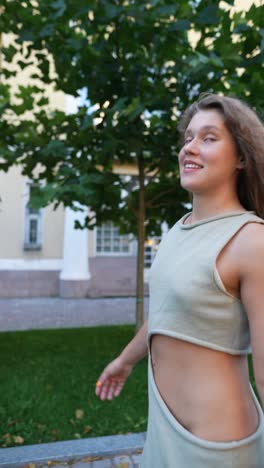 woman walking outdoors in a light green dress