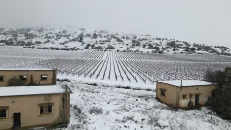 Aerial-drone-flyover-of-abandoned-military-base-barracks-in-Israel-covered-in-snow