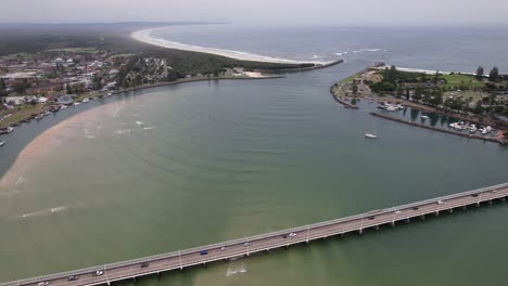 road bridge crossing coolongolook river on tasman sea coast in new south wales, australia. aerial shot