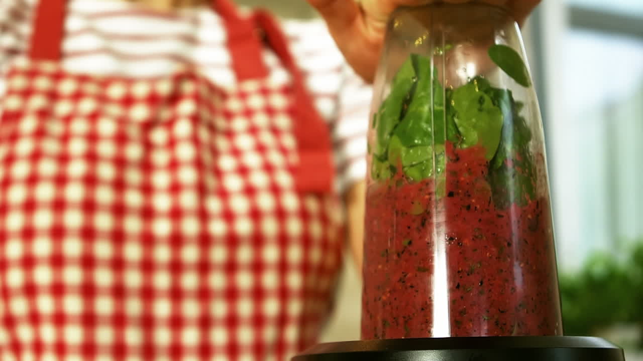 Woman is mixing a smoothie