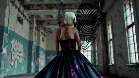 fashion model in abandoned factory with wings