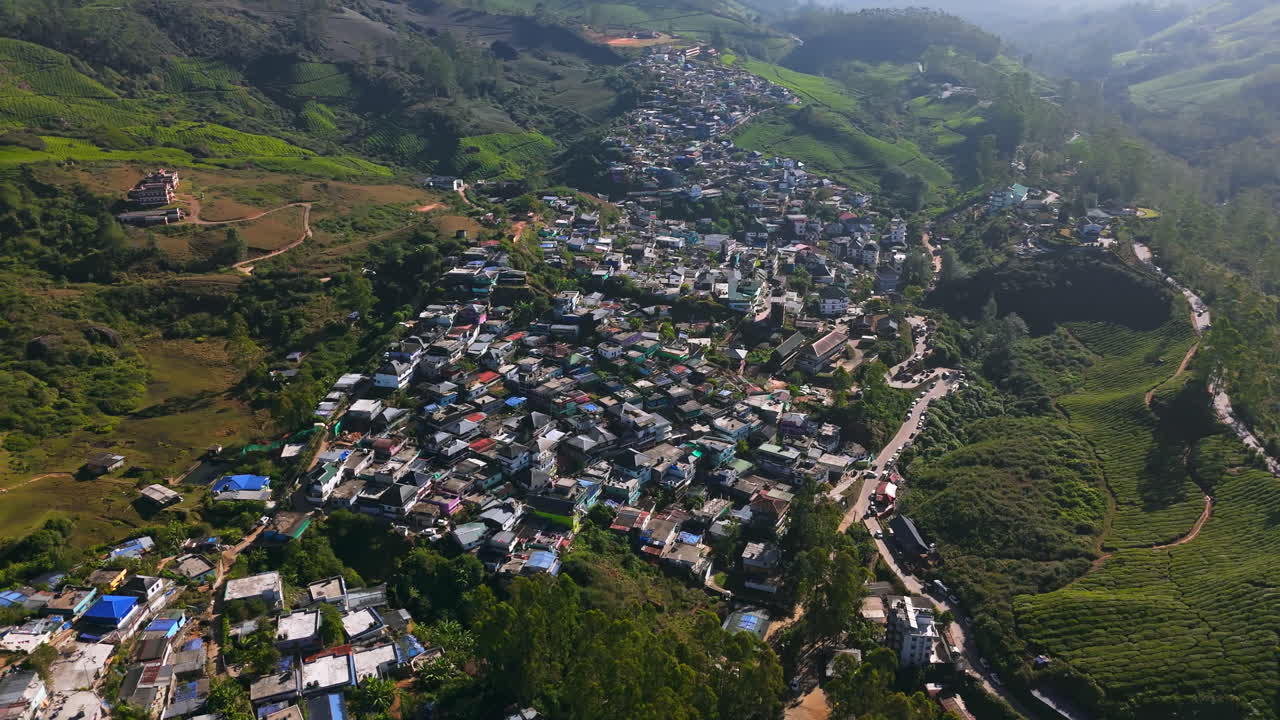 Aerial view around a vibrant neighborhood in Munnar village, in sunny India
