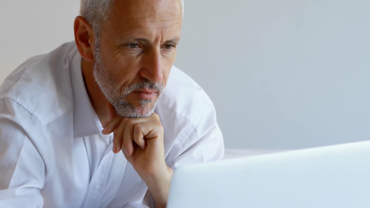 Businessman using laptop in hotel room 4k