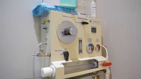 slow motion tilting shot of a colon hydrotherapy machine in a clinic room