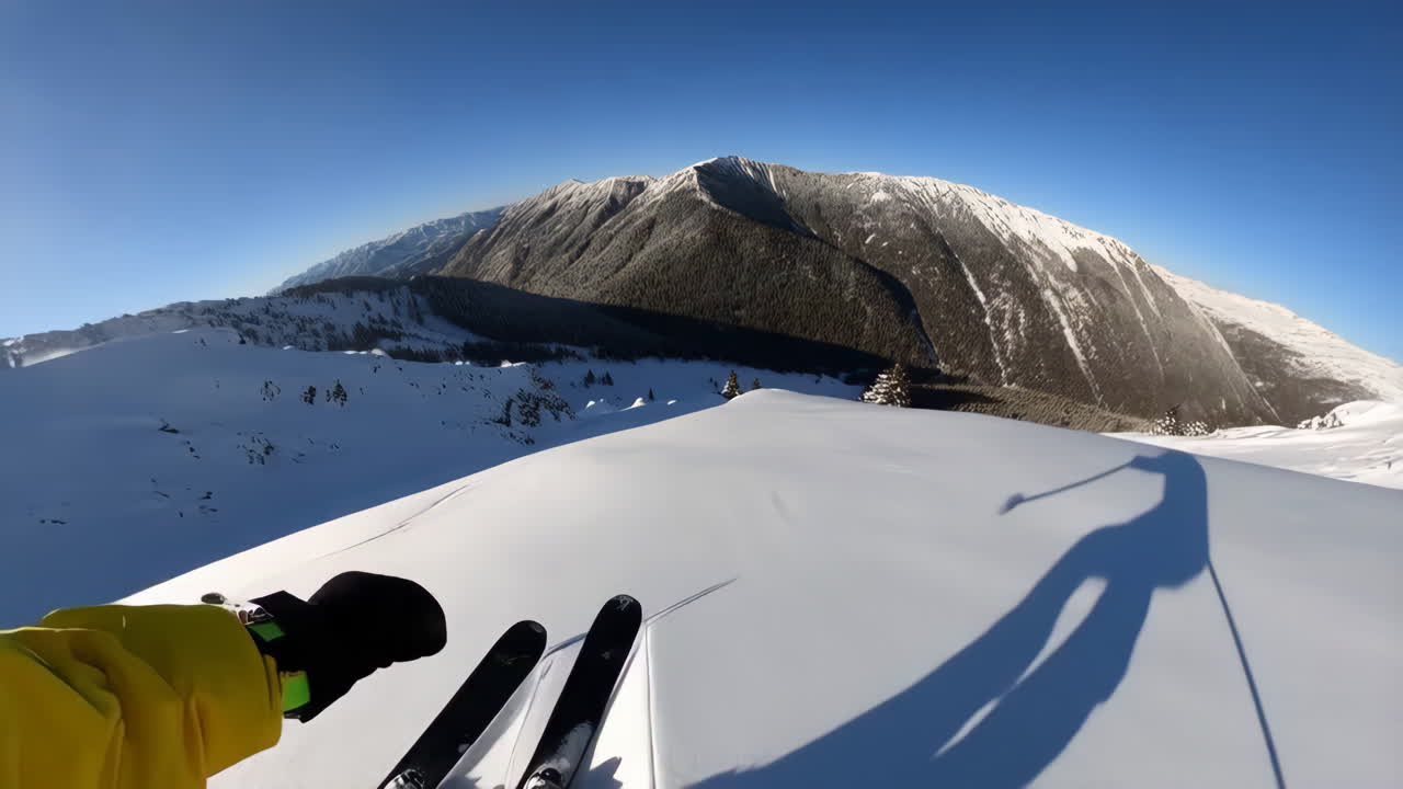 First-Person View of Backcountry Skiing Down a Snowy Mountain