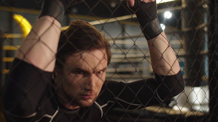 Aggressive sport man looking at camera fitness center. Fit man screaming at gym