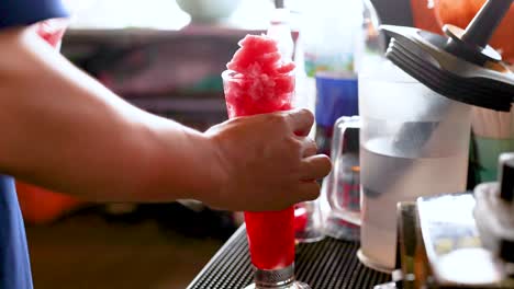 person making watermelon smoothie at street stall in bangkok, thailand