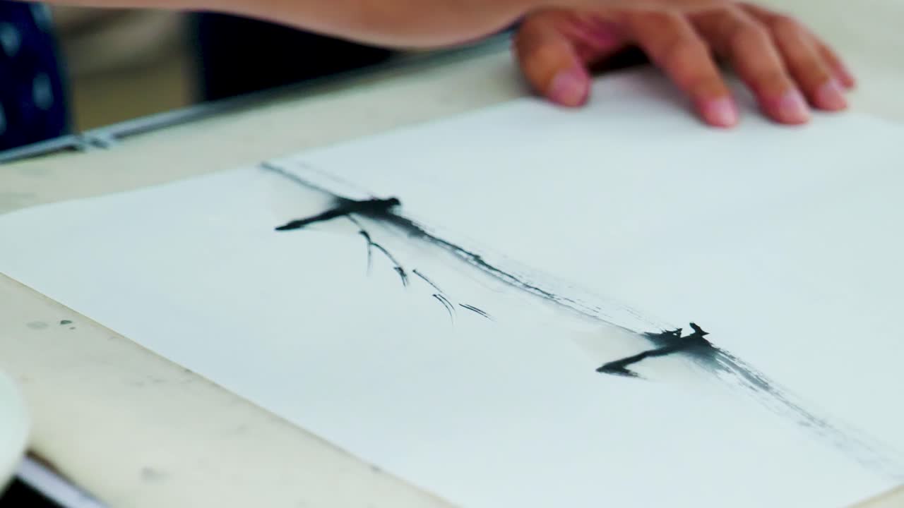 Slow Motion Footage of a Japanese Man Painting a Nihonga, a Traditional Japanese Painting, with Brushes and Black Ink