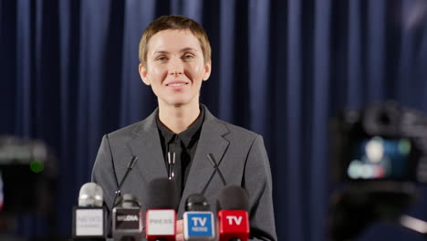 portrait of smiling female public speaker at press conference