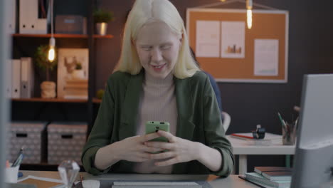 woman in office using smartphone