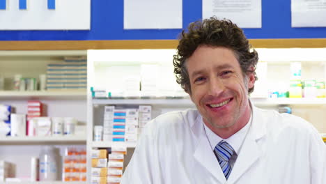 pharmacist giving pill bottle to customer