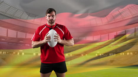 professional rugby player standing in front of a flag and stadium