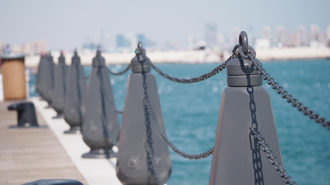 Pier with Chain Fence and Cityscape