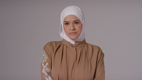 studio portrait of muslim woman wearing hijab against plain background 5