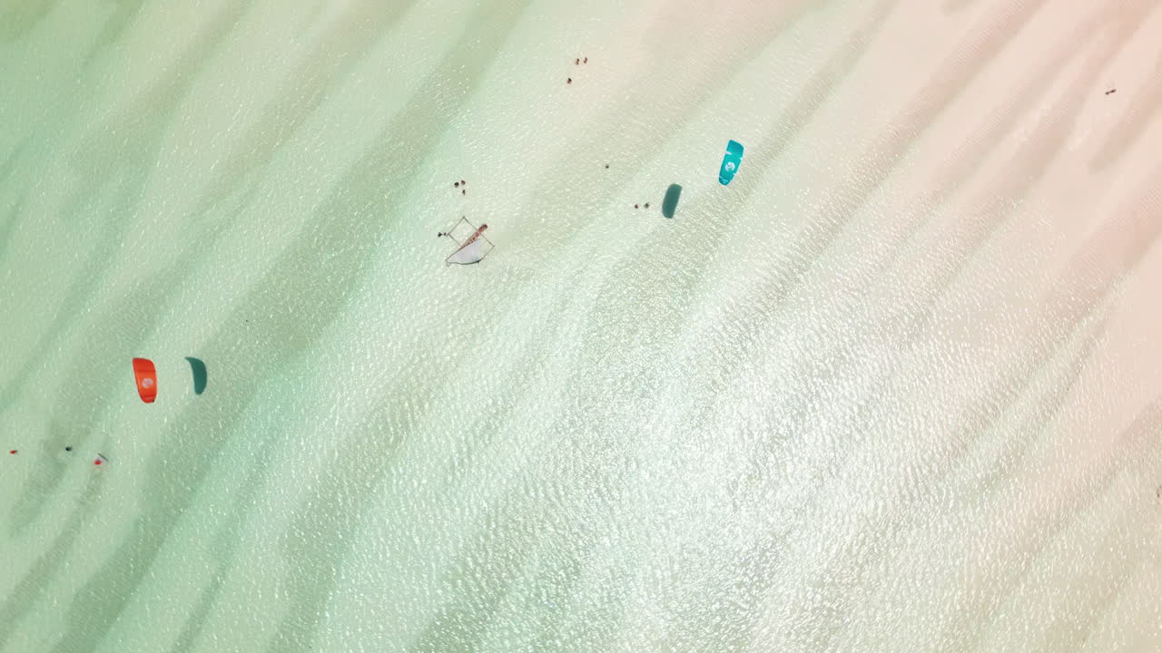 Aerial view of sandbanks and kite surfers in shallow waters in Zanzibar