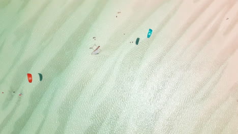 aerial view of sandbanks and kite surfers in shallow waters in zanzibar