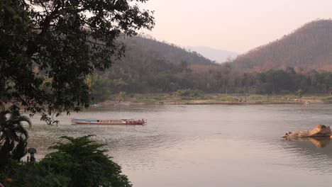 boats-floating-down-the-Mekong-river-in-Luang-Prabang,-Laos-traveling-Southeast-Asia