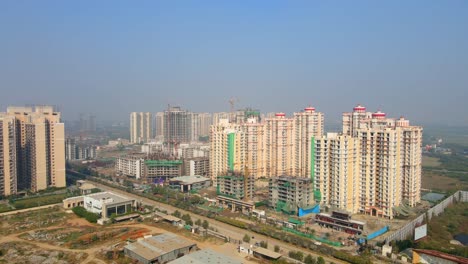 aerial drone shot capturing a massive high rise construction site in noida india