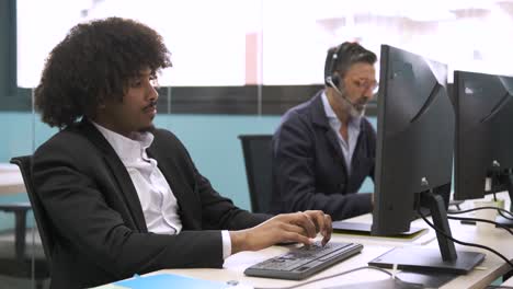 anxious businessman using computer in coworking workspace